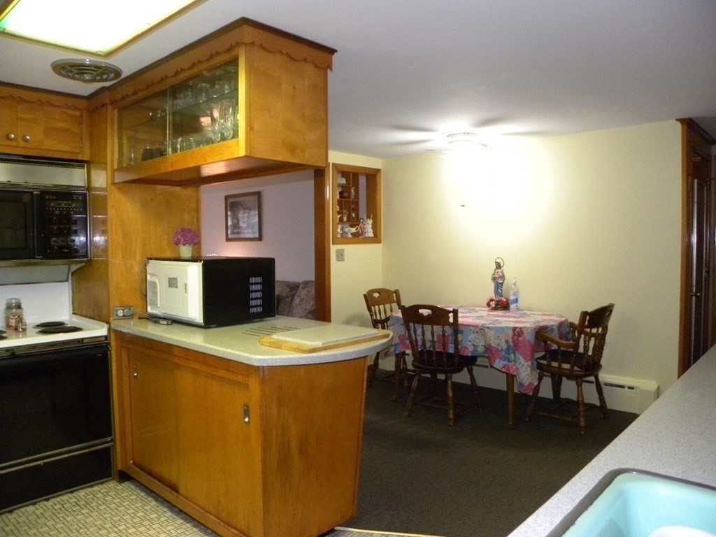 8 Everett Avenue Webster, MA 01570 - Photo 18 of 29 a dining room with a wooden table and chairs