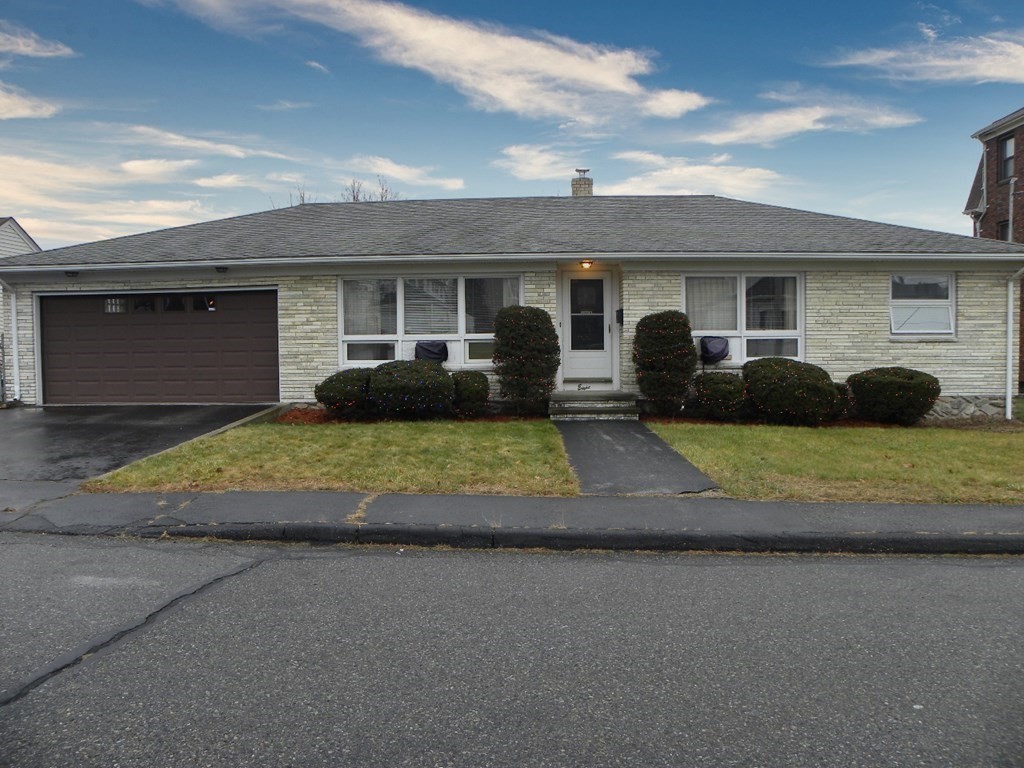 8 Everett Avenue Webster, MA 01570 - Photo 2 of 29 a front view of a house with a yard and garage