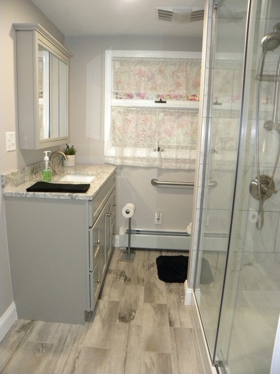 8 Everett Avenue Webster, MA 01570 - Photo 21 of 29 a bathroom with a sink a toilet and shower