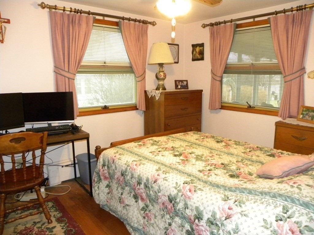 8 Everett Avenue Webster, MA 01570 - Photo 23 of 29 a bedroom with a bed and a flat tv screen next to a window