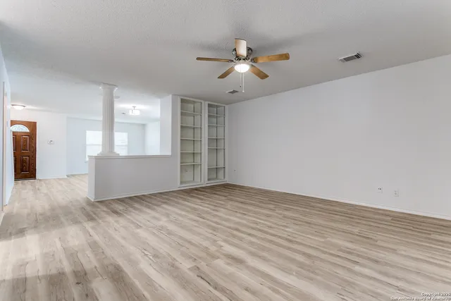 a view of wooden floor and windows in a room