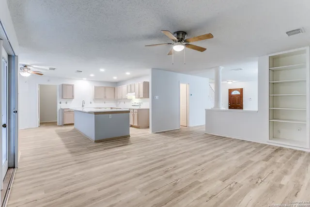 a view of kitchen with sink and refrigerator