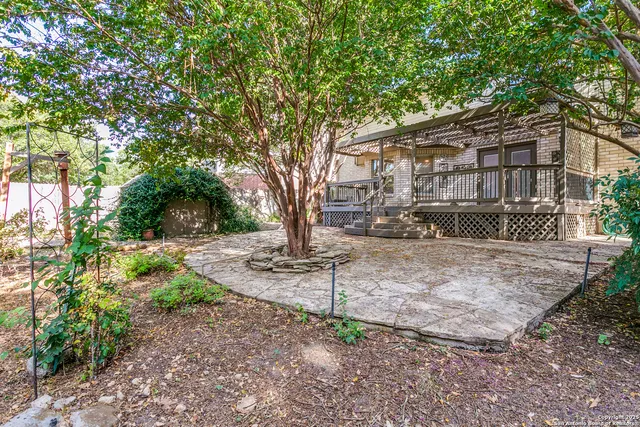 a tree in front of a white house