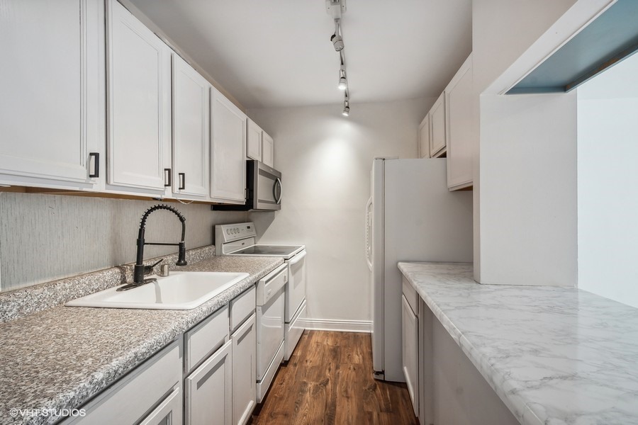 535 North Michigan Avenue, Unit 2505 Chicago, IL 60611 - Photo 4 of 14 a kitchen with stainless steel appliances granite countertop a sink stove and refrigerator