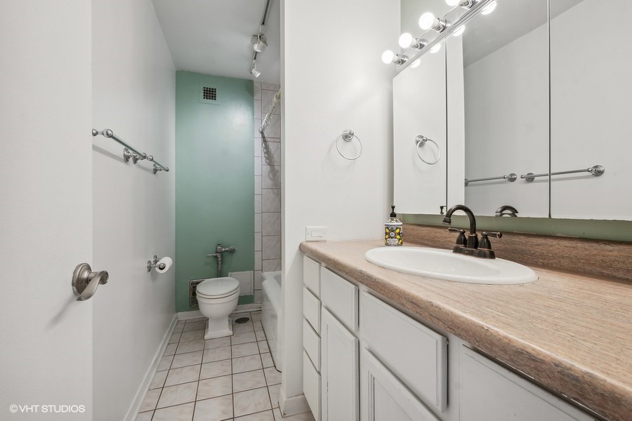 535 North Michigan Avenue, Unit 2505 Chicago, IL 60611 - Photo 7 of 14 a bathroom with a sink a toilet and shower