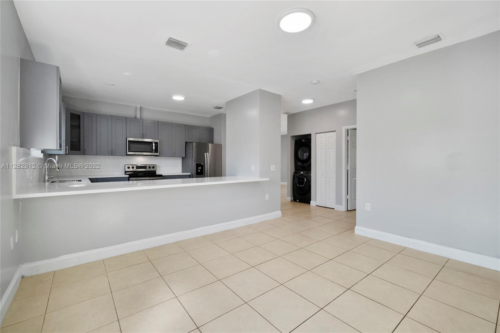 Gladeview Miami, FL 33147 - Photo 11 of 31 a view of kitchen with refrigerator sink and cabinets