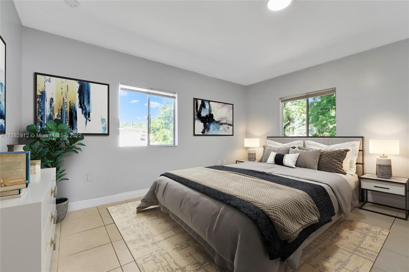 Gladeview Miami, FL 33147 - Photo 15 of 31 a bedroom with a bed and a potted plant