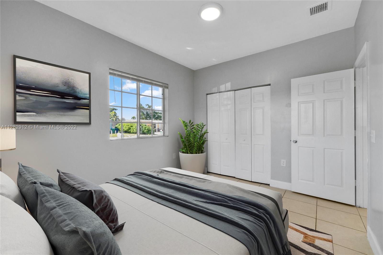 Gladeview Miami, FL 33147 - Photo 20 of 31 a bedroom with a bed and a painting on the wall