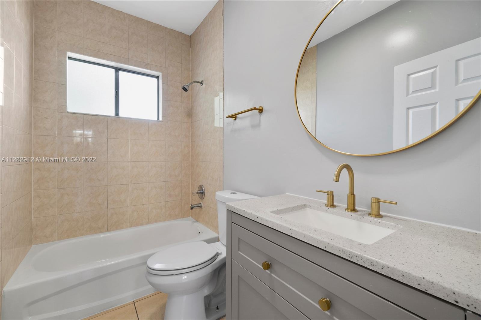 Gladeview Miami, FL 33147 - Photo 24 of 31 a bathroom with a sink a toilet and a mirror