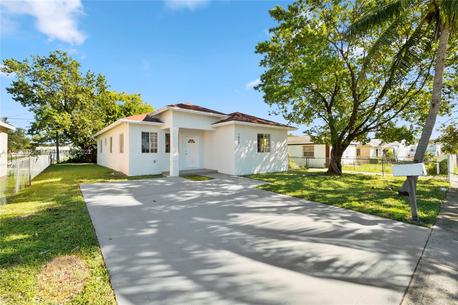 Gladeview Miami, FL 33147 - Photo 3 of 31 a view of a white house with a yard and large trees