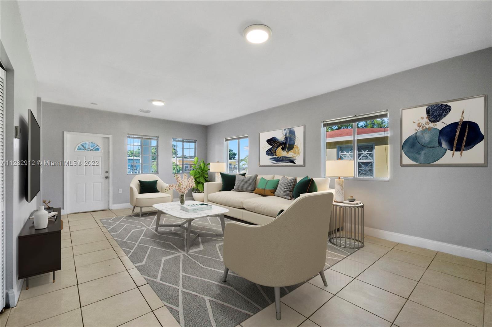 Gladeview Miami, FL 33147 - Photo 4 of 31 a living room with furniture a flat screen tv and a fireplace