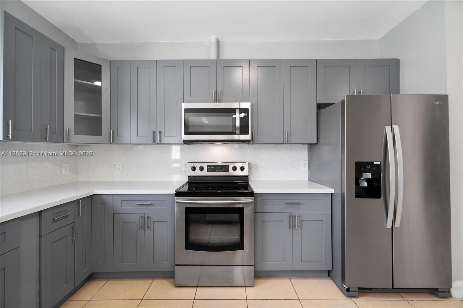 Gladeview Miami, FL 33147 - Photo 8 of 31 a kitchen with granite countertop a stove microwave and refrigerator