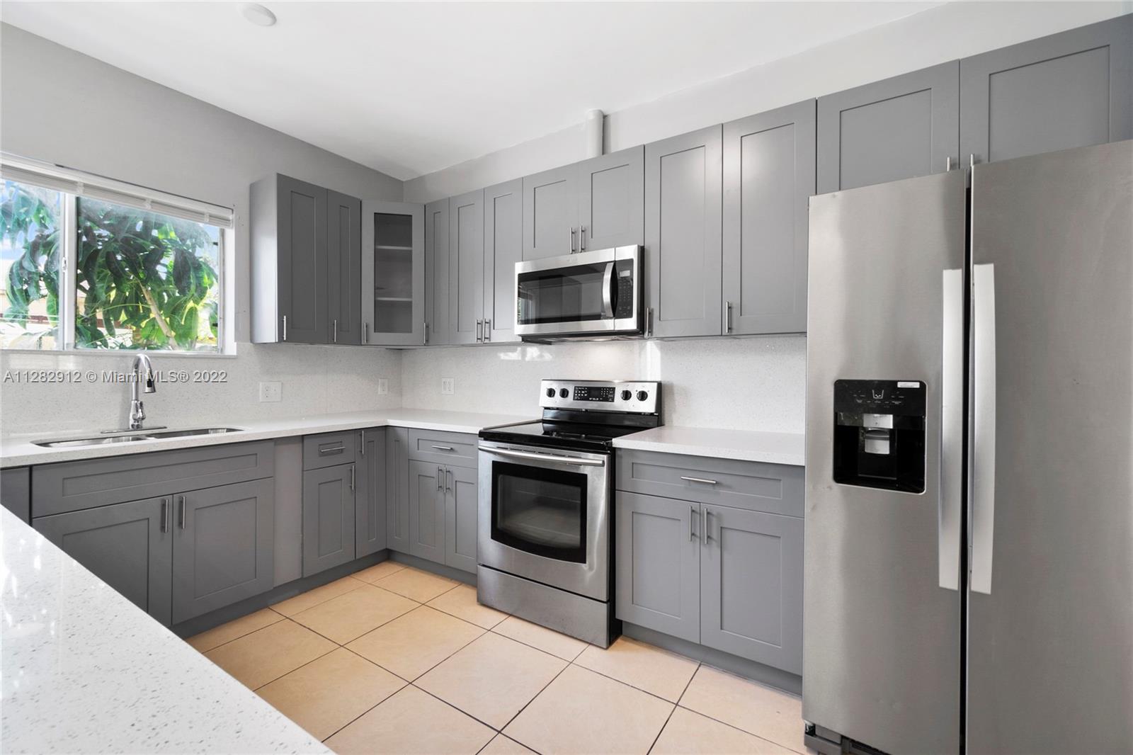 Gladeview Miami, FL 33147 - Photo 10 of 31 a kitchen with a sink stove and refrigerator