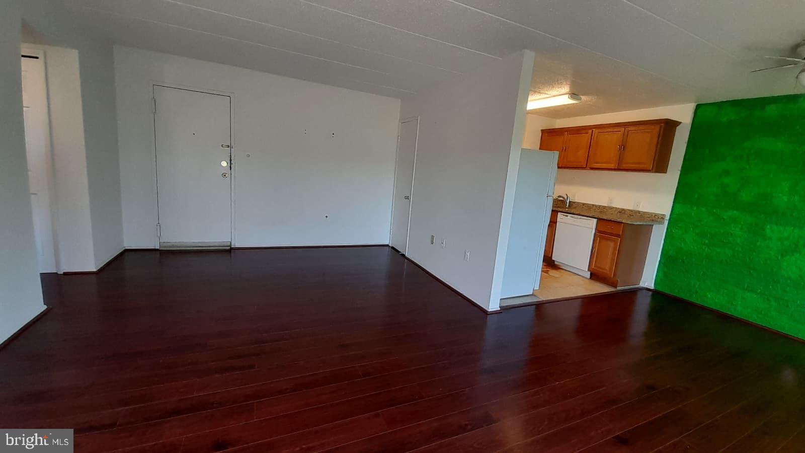 1804 Metzerott Road, Unit 303 Hyattsville, MD 20783 - Photo 4 of 13 an empty room with wooden floor and windows