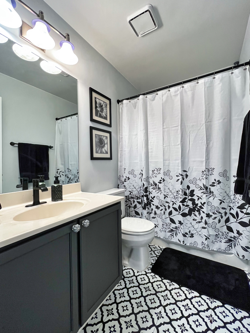 17807 Braewick Road Gurnee, IL 60031 - Photo 19 of 24 a bathroom with a sink toilet and mirror
