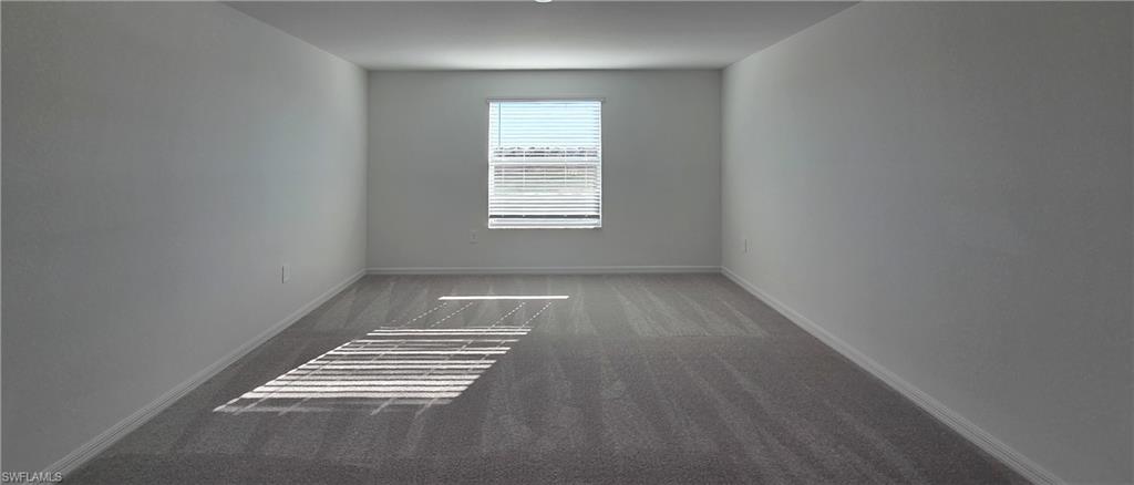 13329 Turnleaf Boulevard Punta Gorda, FL 33955 - Photo 11 of 23 Spare room with dark carpet and baseboards