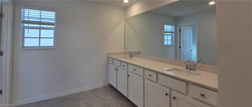 13329 Turnleaf Boulevard Punta Gorda, FL 33955 - Photo 15 of 23 Full bath with double vanity, light tile patterned flooring, and recessed lighting