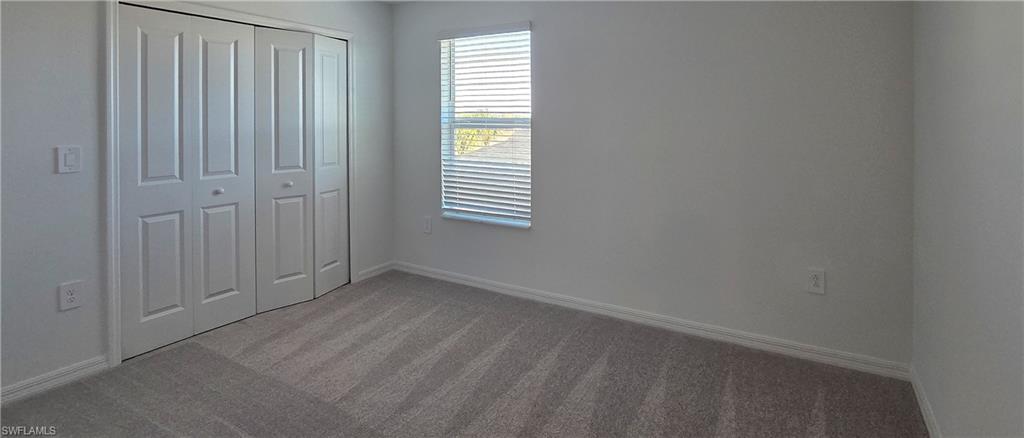 13329 Turnleaf Boulevard Punta Gorda, FL 33955 - Photo 16 of 23 Unfurnished bedroom featuring carpet and a closet