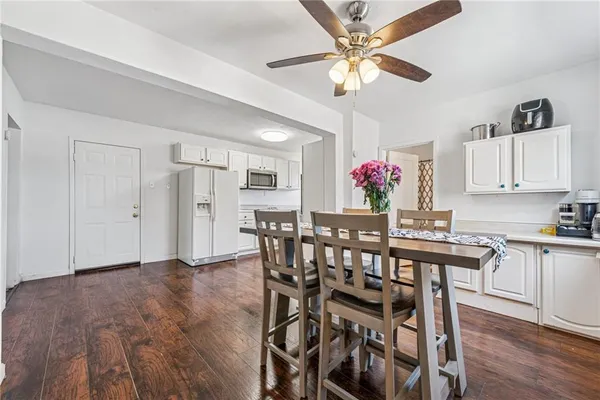 a view of a dining room with furniture and wooden floor