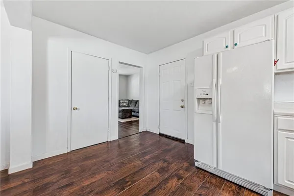 a bedroom with a bed and two windows