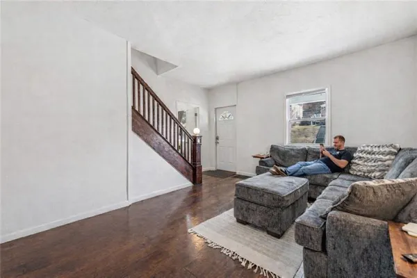 a living room with furniture and stairs