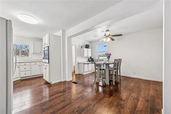 a view of a dining room with furniture and wooden floor