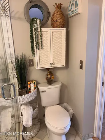 a bathroom with a toilet a sink and a mirror