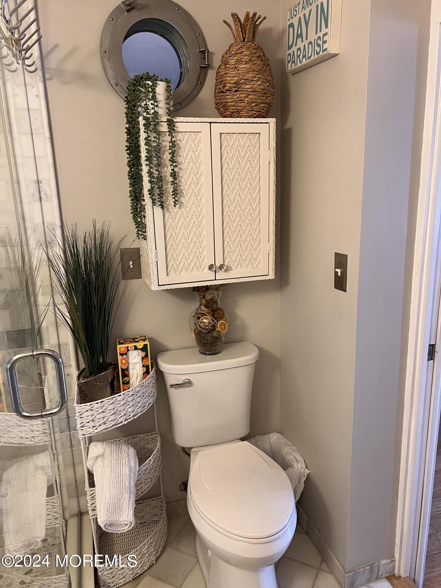 14 Cook Street, Unit DOWNSTAIRS Monmouth Beach, NJ 07750 - Photo 11 of 33 a bathroom with a toilet a sink and a mirror