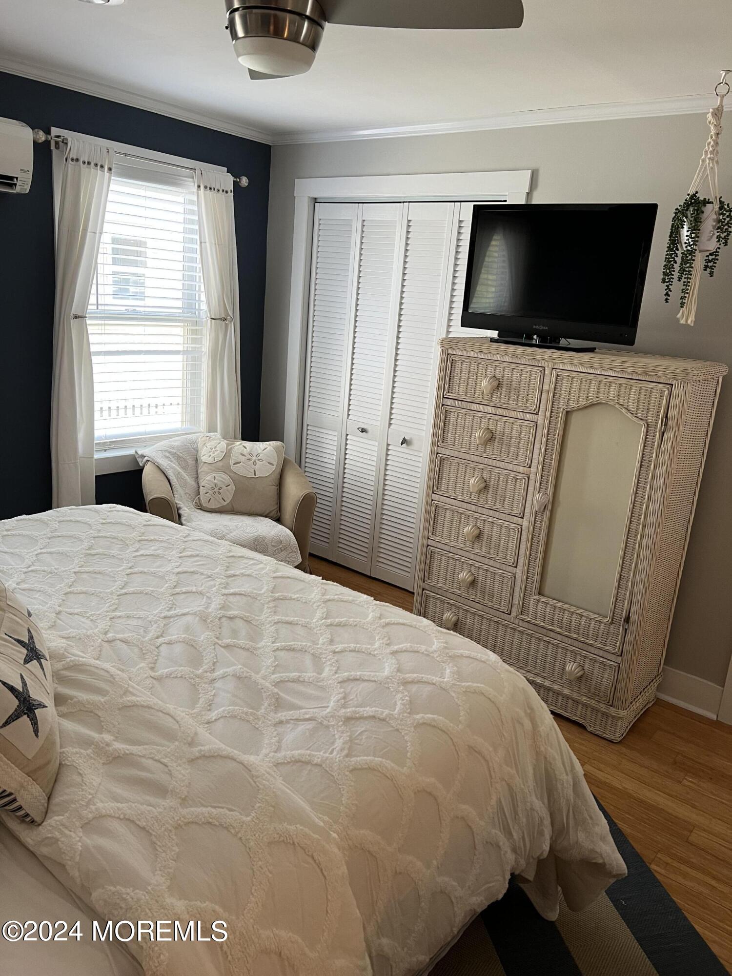 14 Cook Street, Unit DOWNSTAIRS Monmouth Beach, NJ 07750 - Photo 15 of 33 a bedroom with a bed and a flat screen tv