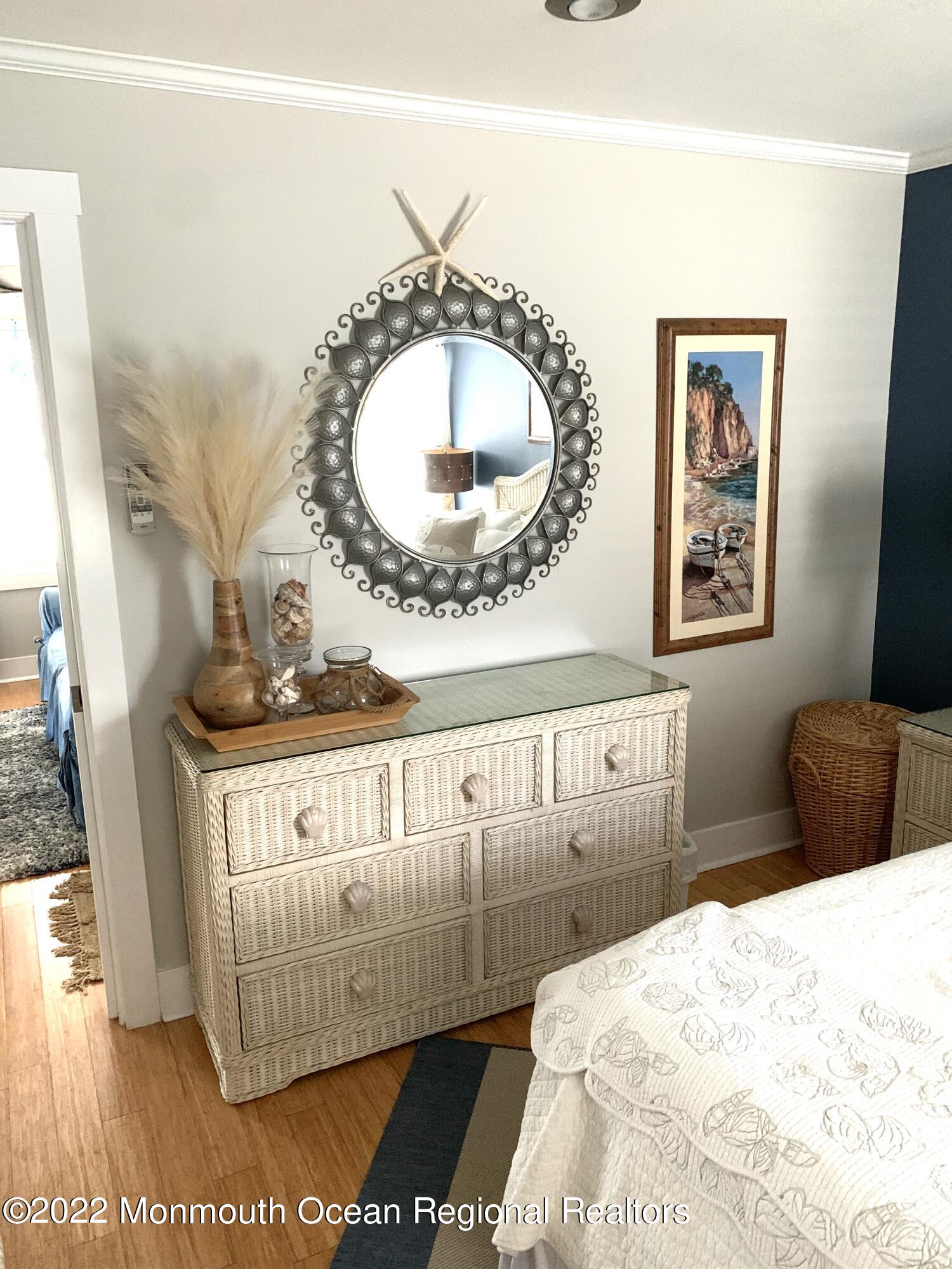 14 Cook Street, Unit DOWNSTAIRS Monmouth Beach, NJ 07750 - Photo 18 of 33 a bedroom with a bed and a mirror