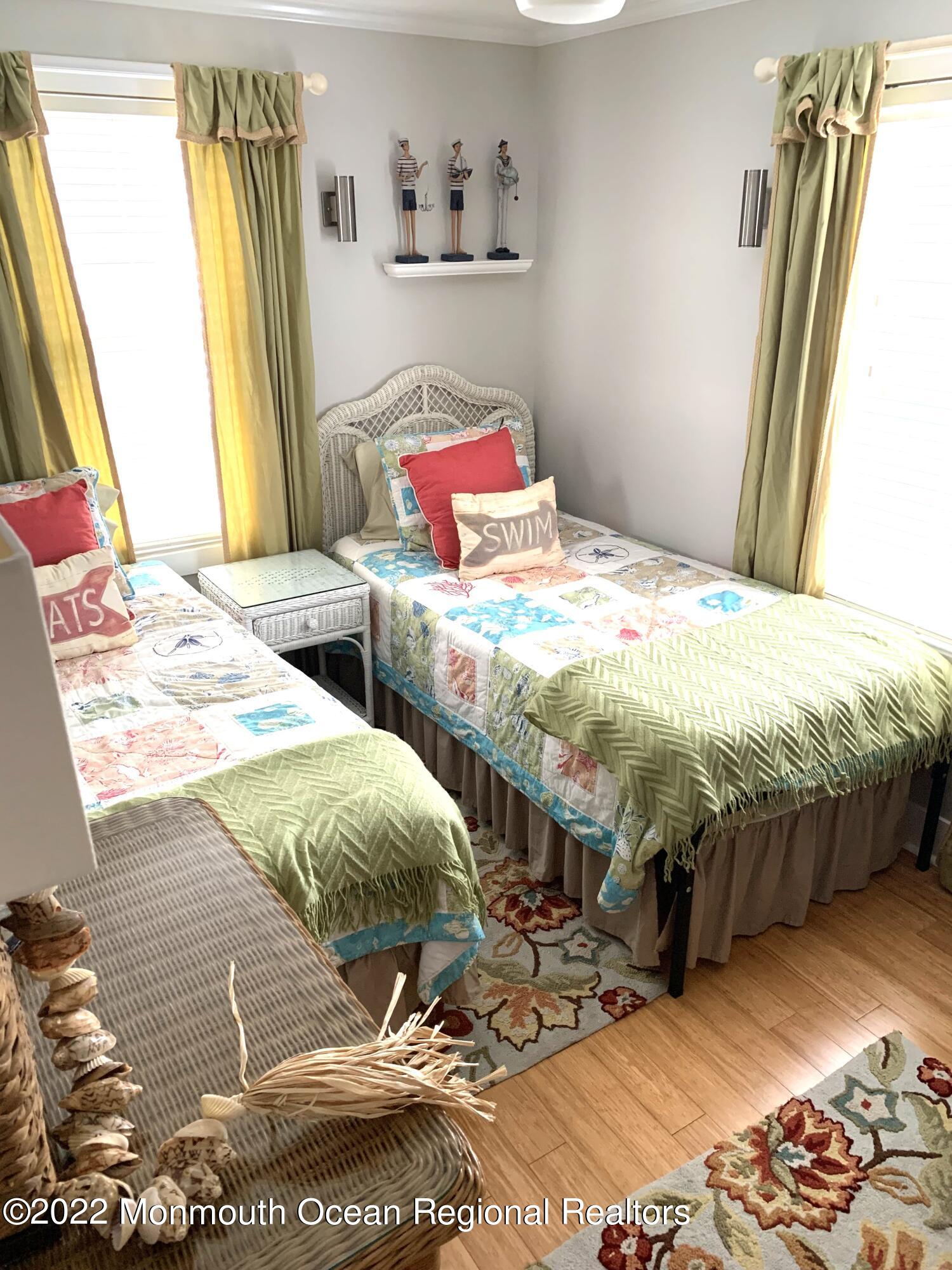 14 Cook Street, Unit DOWNSTAIRS Monmouth Beach, NJ 07750 - Photo 20 of 33 a bedroom with a bed and wooden floor