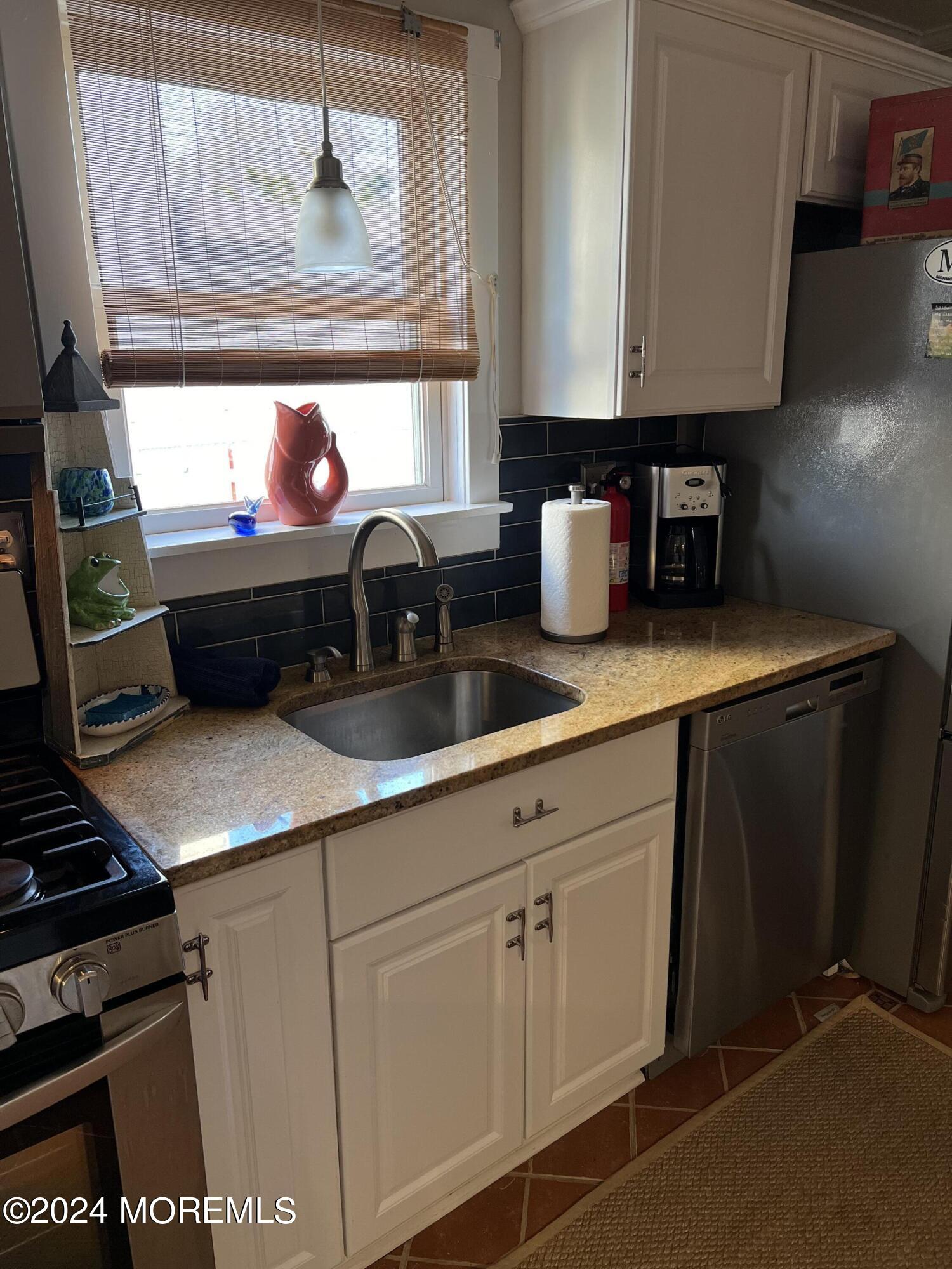 14 Cook Street, Unit DOWNSTAIRS Monmouth Beach, NJ 07750 - Photo 6 of 33 a kitchen with a sink cabinets and a stove top oven