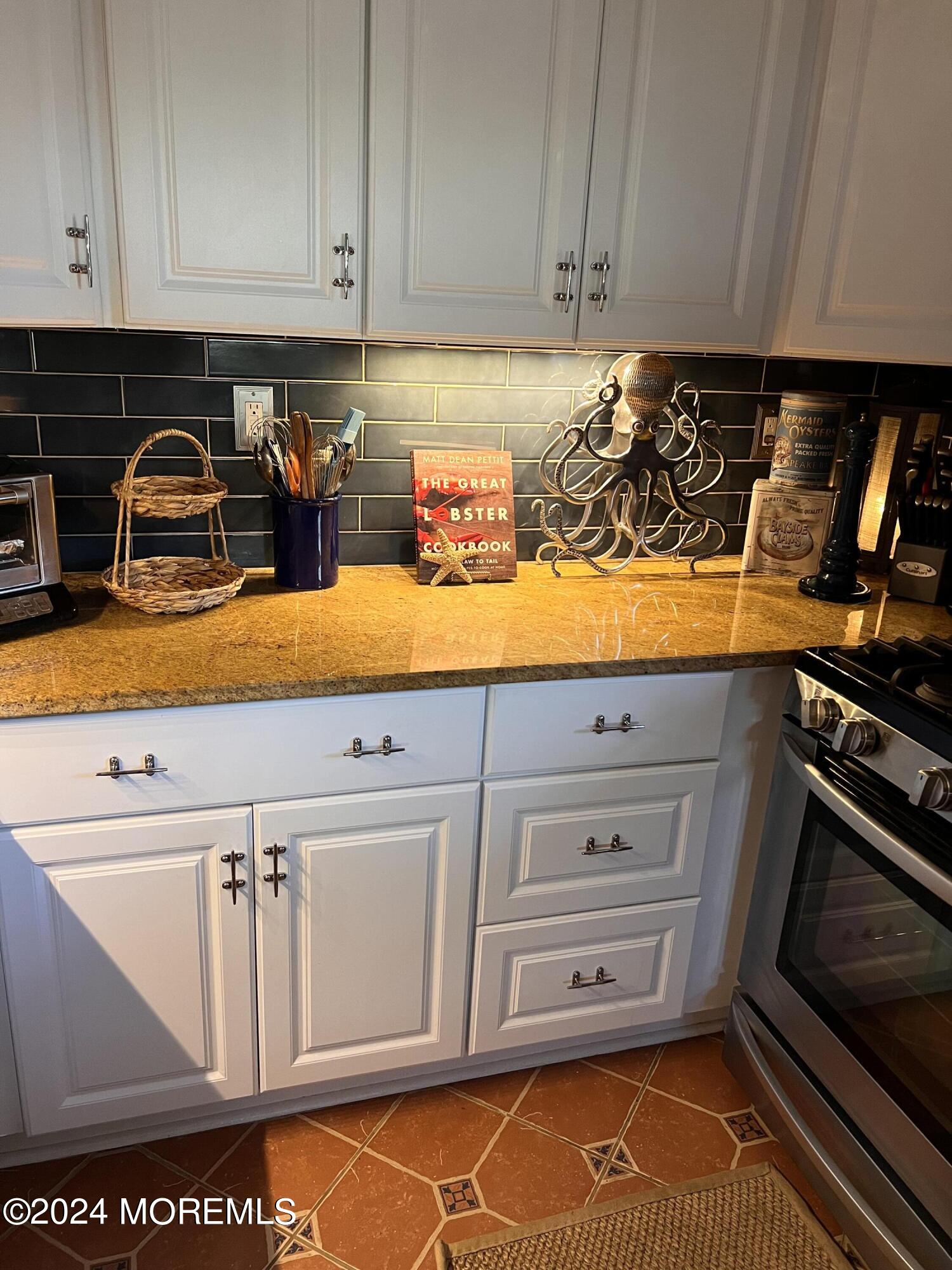 14 Cook Street, Unit DOWNSTAIRS Monmouth Beach, NJ 07750 - Photo 7 of 33 a kitchen with an oven a stove and cabinets