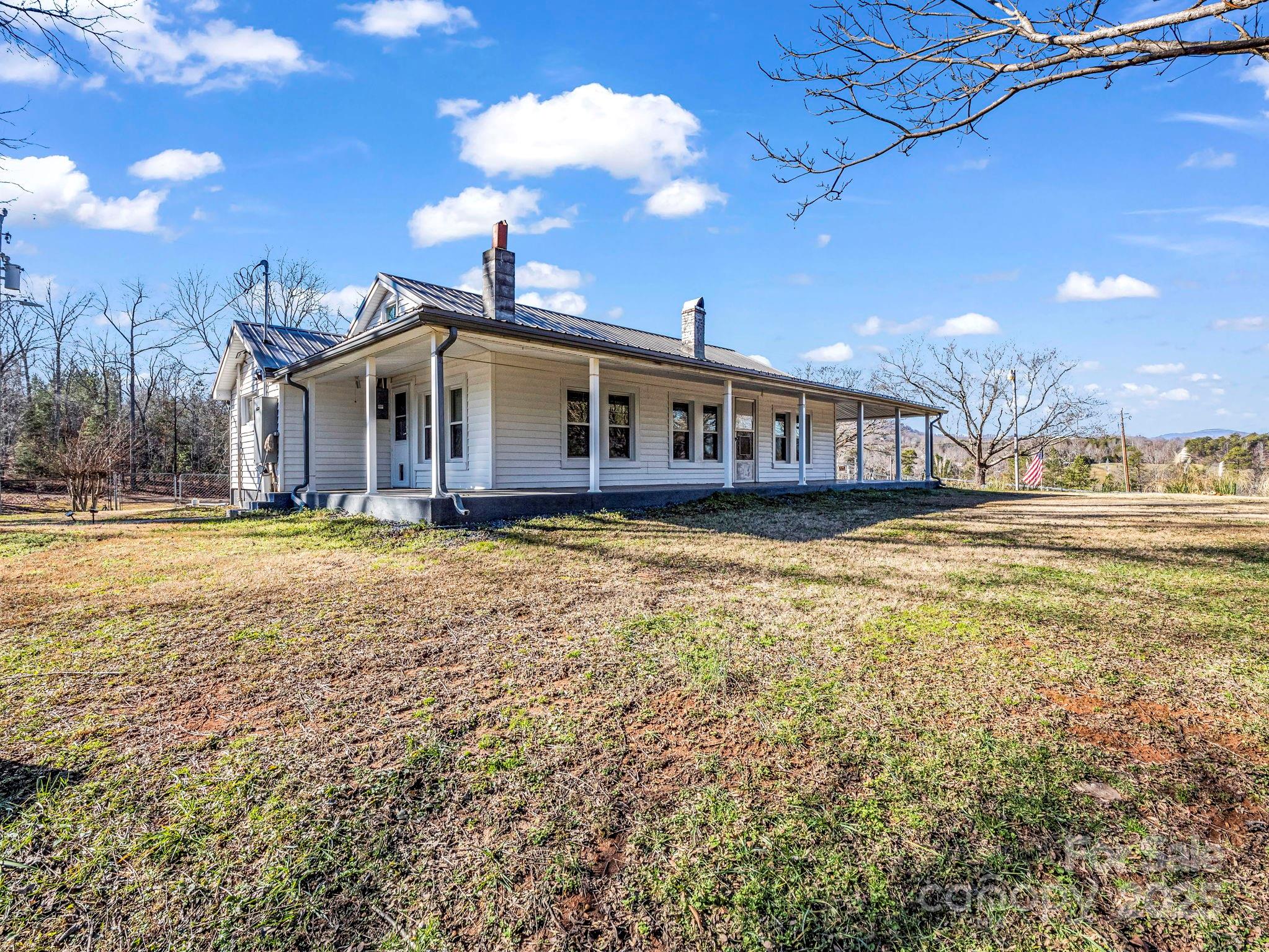 620 Smith Waldrop Road Columbus, NC 28722 - Photo 12 of 42 a view of a house with a big yard and large trees