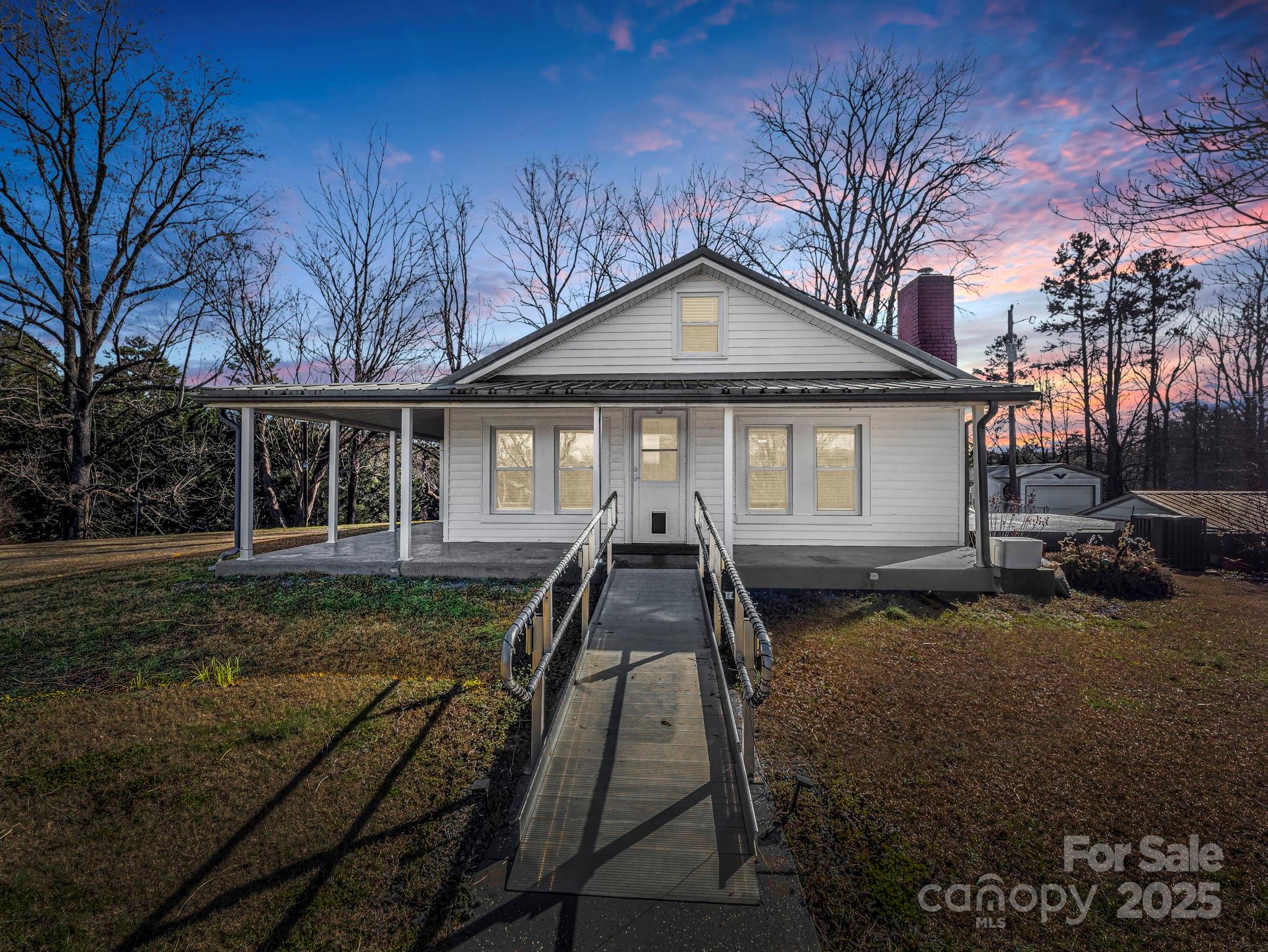 620 Smith Waldrop Road Columbus, NC 28722 - Photo 14 of 42 a front view of a house with garden