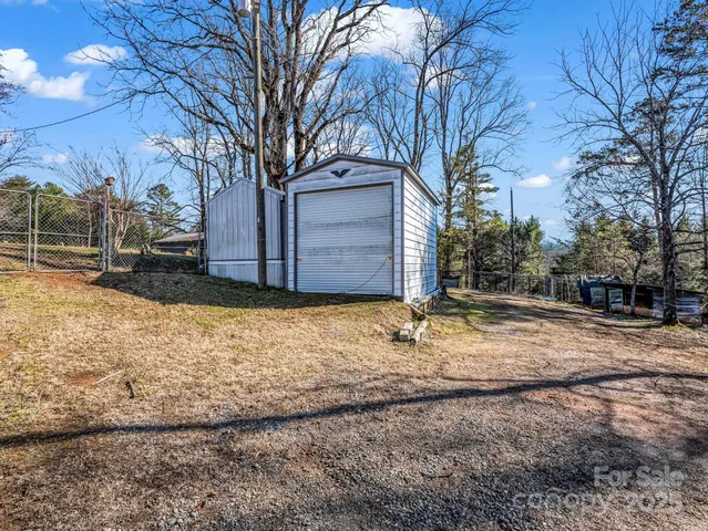 a view of a yard covered with snow in front of house