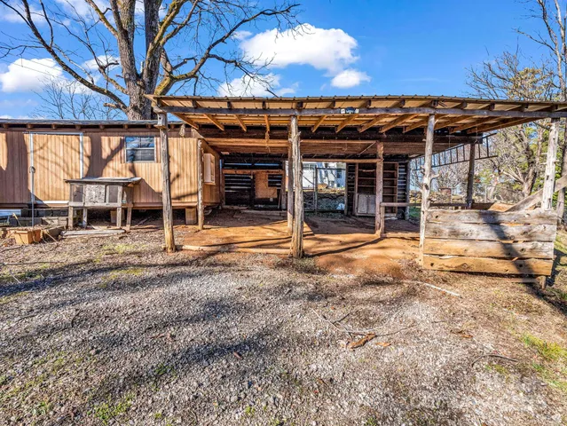 a backyard of a house with barbeque oven table and chairs