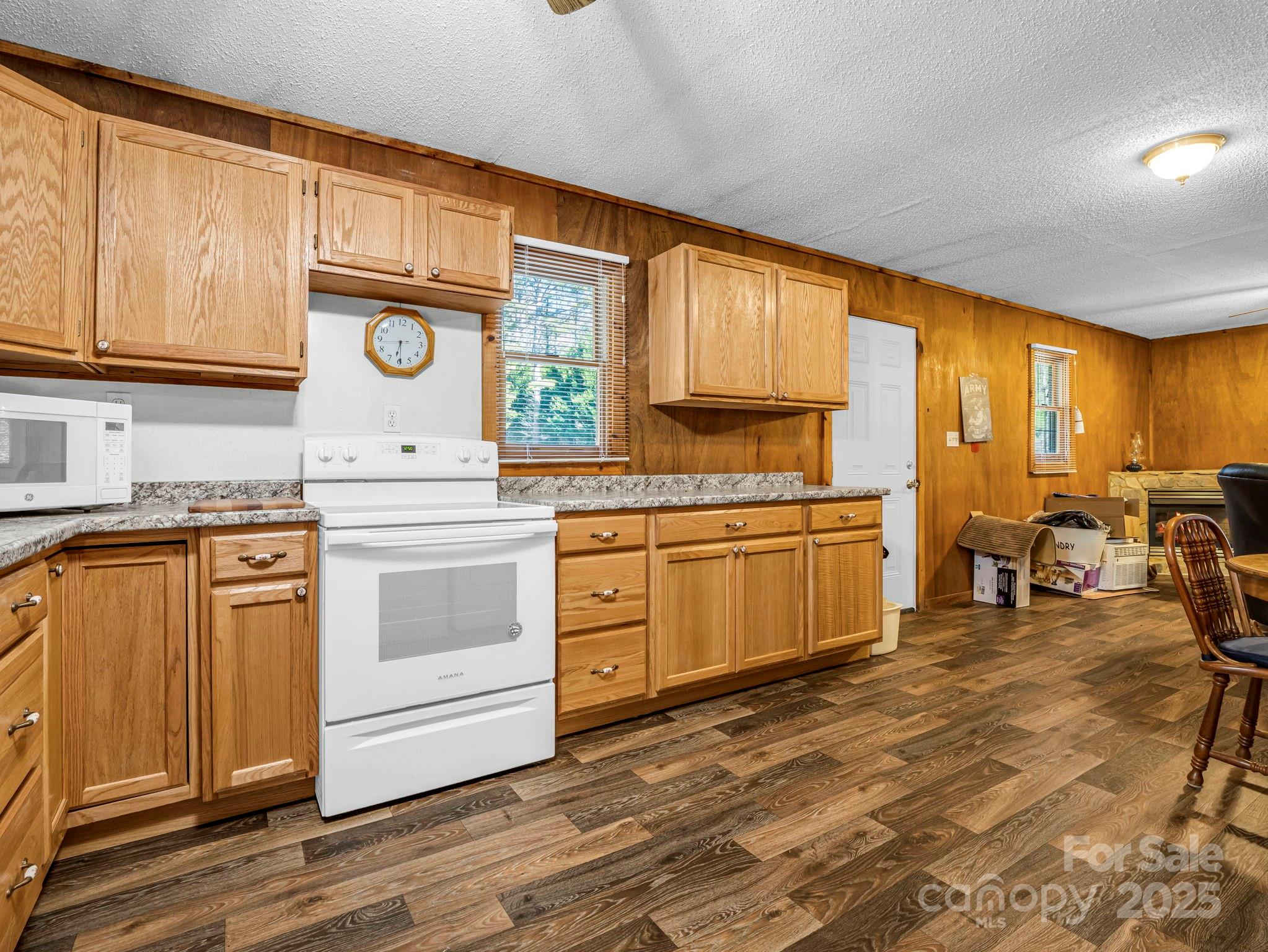 620 Smith Waldrop Road Columbus, NC 28722 - Photo 29 of 42 a kitchen with a stove window and cabinets
