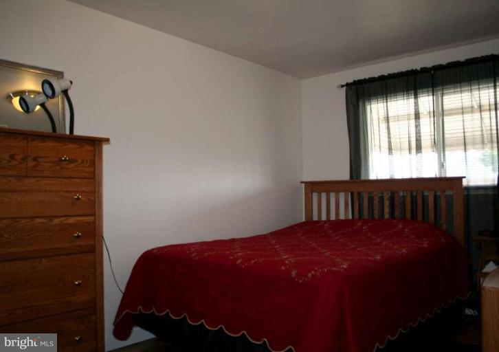 7811 Harold Road Dundalk, MD 21222 - Photo 9 of 10 a bed sitting in a bedroom next to a window