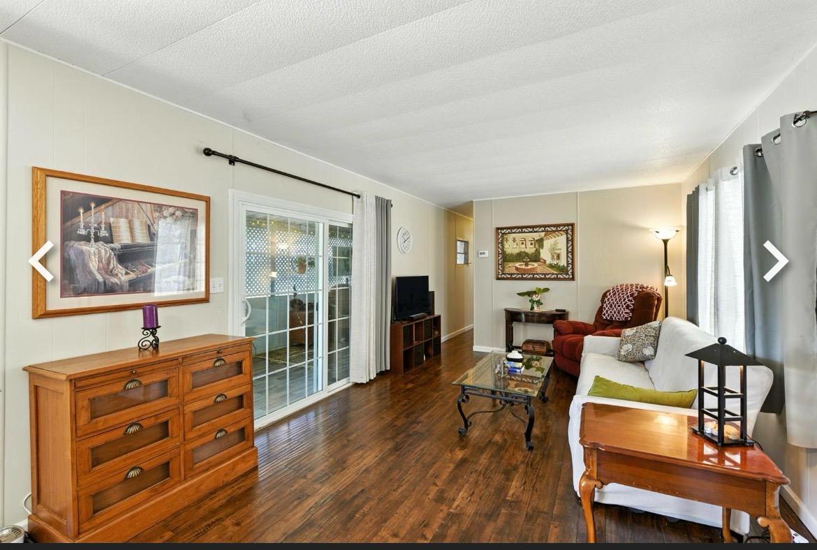 9060 Auburn Folsom Road, Unit 32 Granite Bay, CA 95746 - Photo 9 of 18 a living room with furniture and a flat screen tv