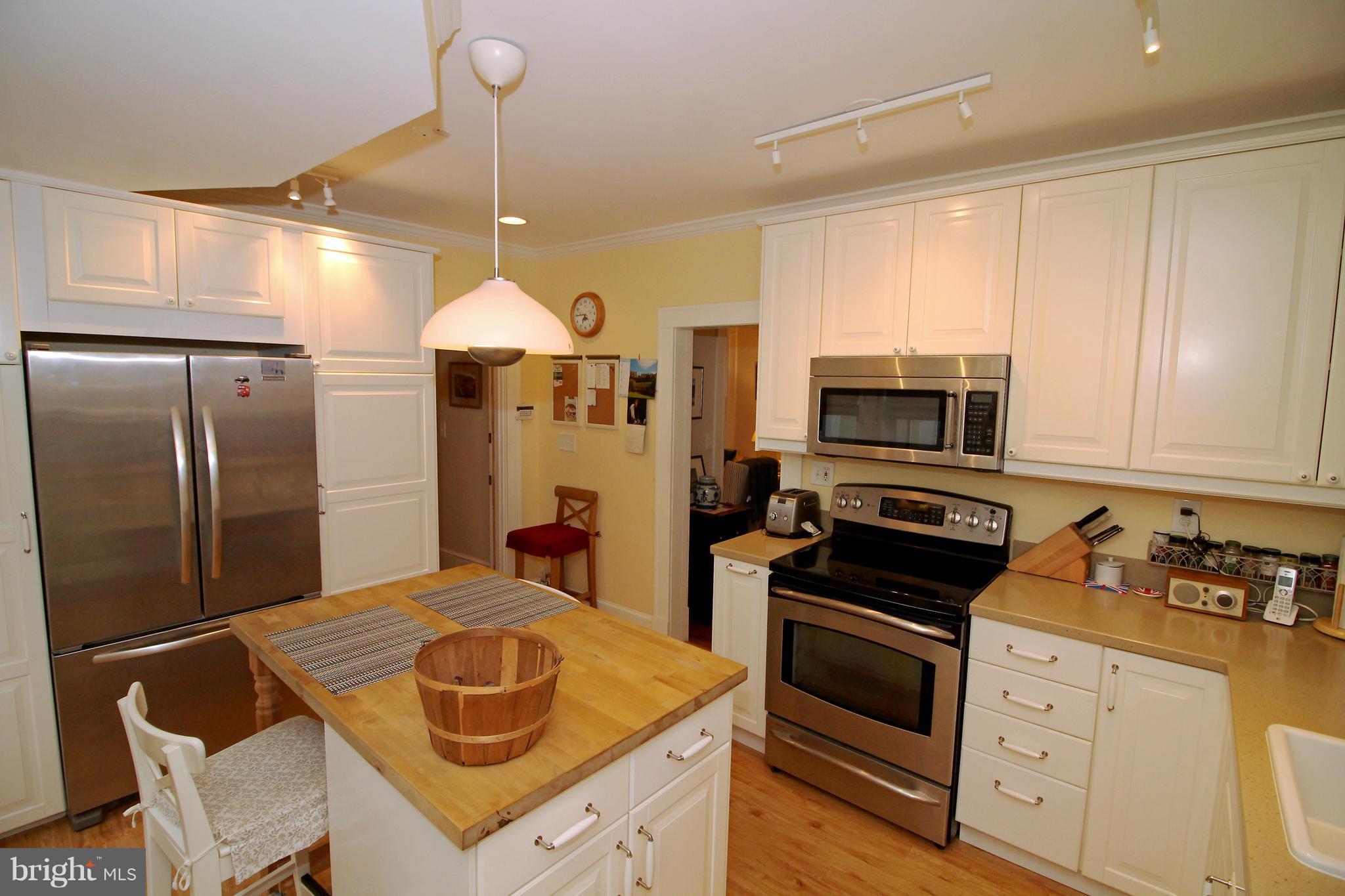 2707 Goodwood Road Baltimore, MD 21214 - Photo 14 of 31 a kitchen with stainless steel appliances granite countertop a stove refrigerator and cabinets