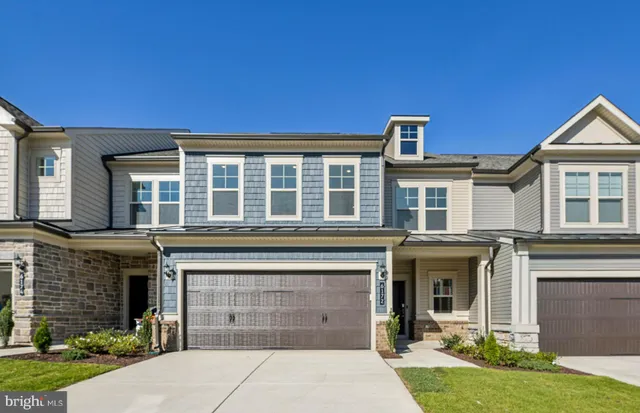 an aerial view of a house with swimming pool garden and patio