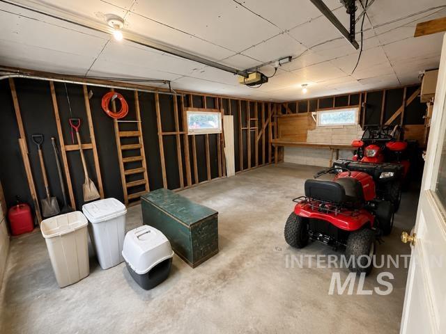 1301 Ridge Street Pocatello, ID 83201 - Photo 2 of 12 Spacious garage featuring a concrete floor, exposed wood framing, and built-in shelving