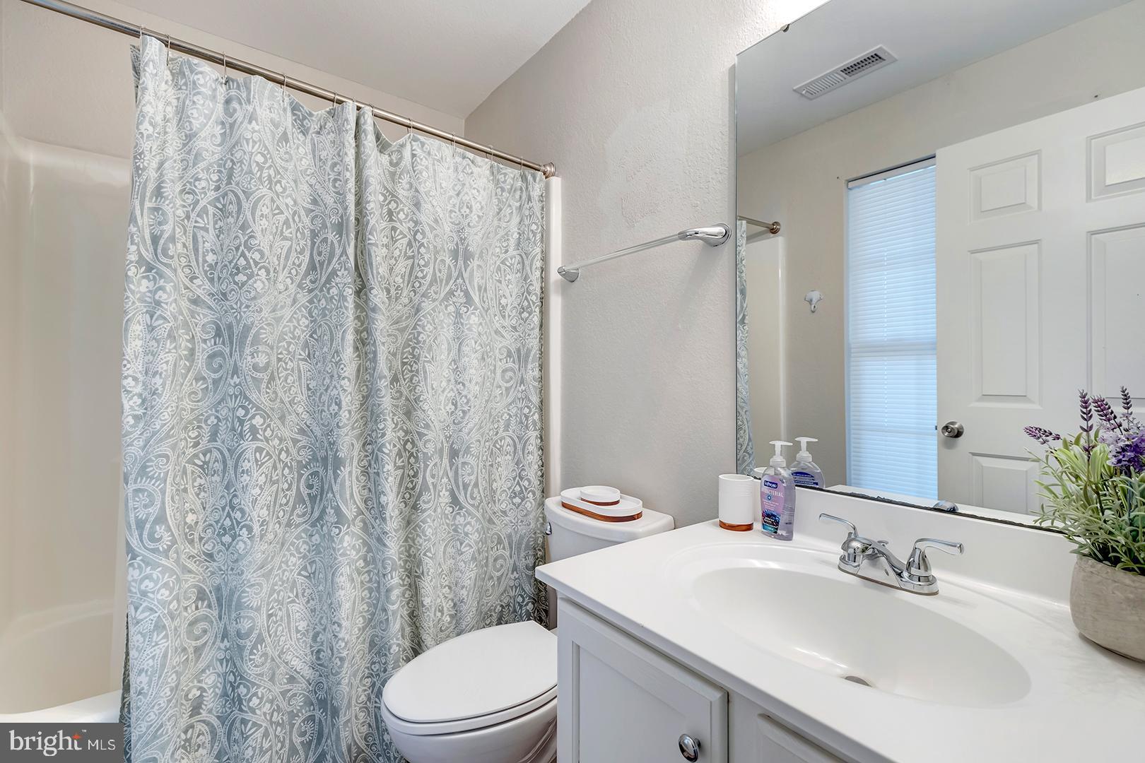 26 Dockside Drive Millville, DE 19967 - Photo 13 of 83 a bathroom with a sink a toilet and shower curtain