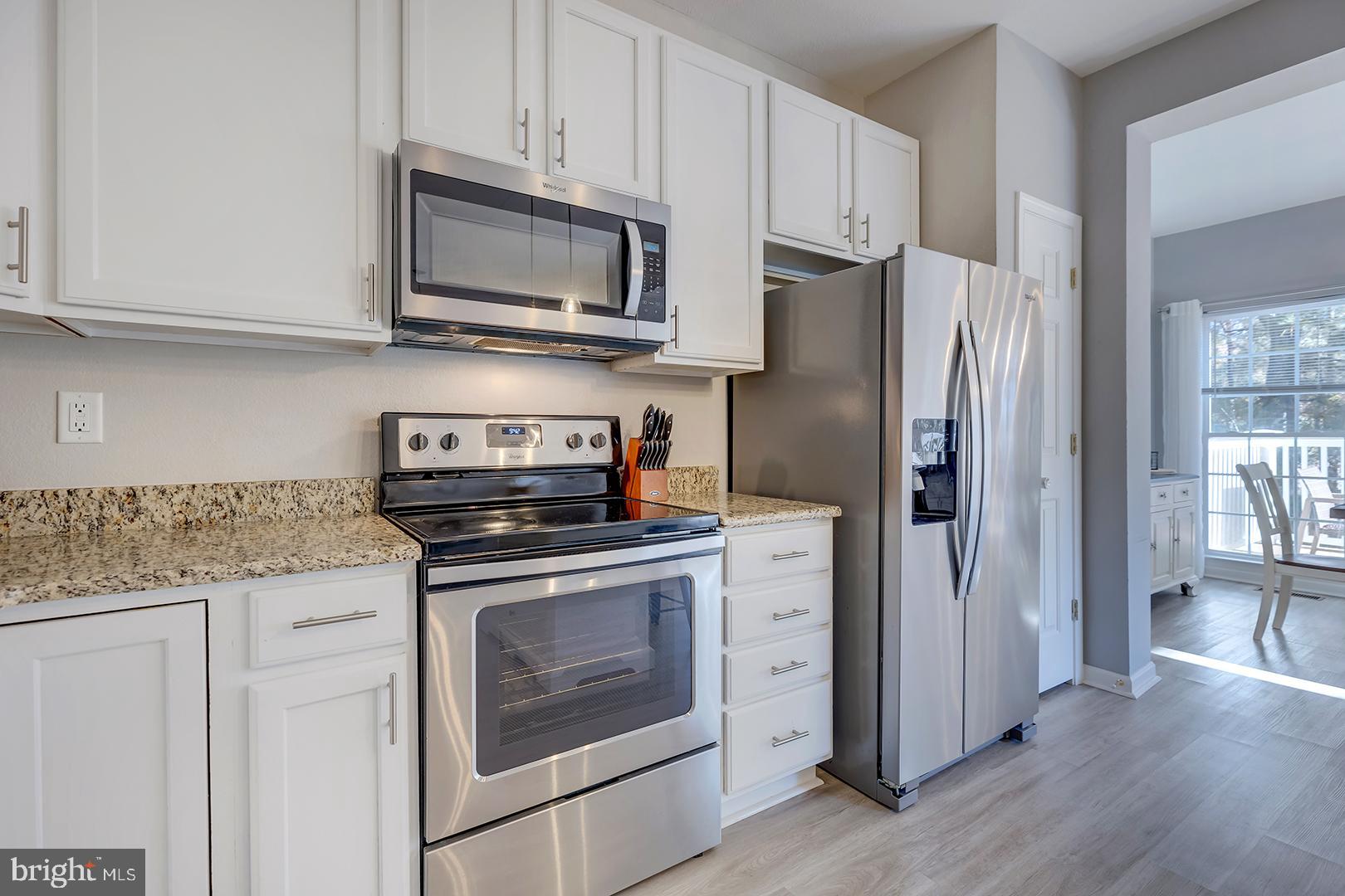 26 Dockside Drive Millville, DE 19967 - Photo 20 of 83 a kitchen with stainless steel appliances granite countertop a refrigerator stove and sink