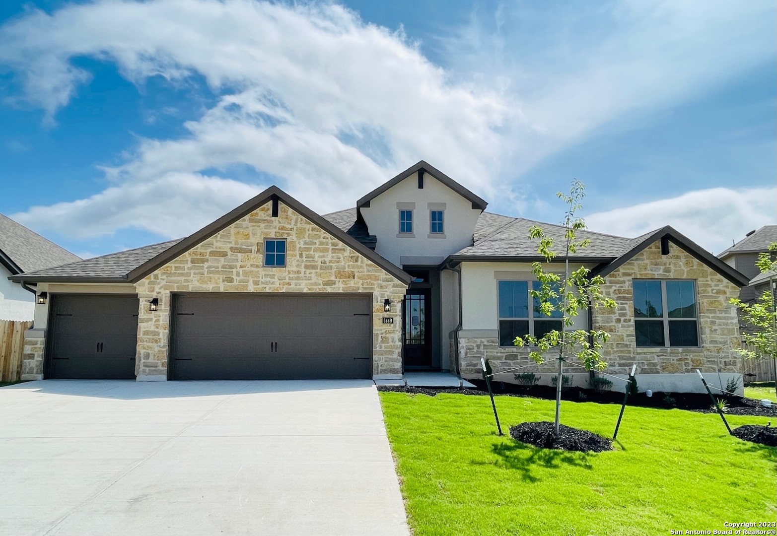 a front view of house with a garden and plants