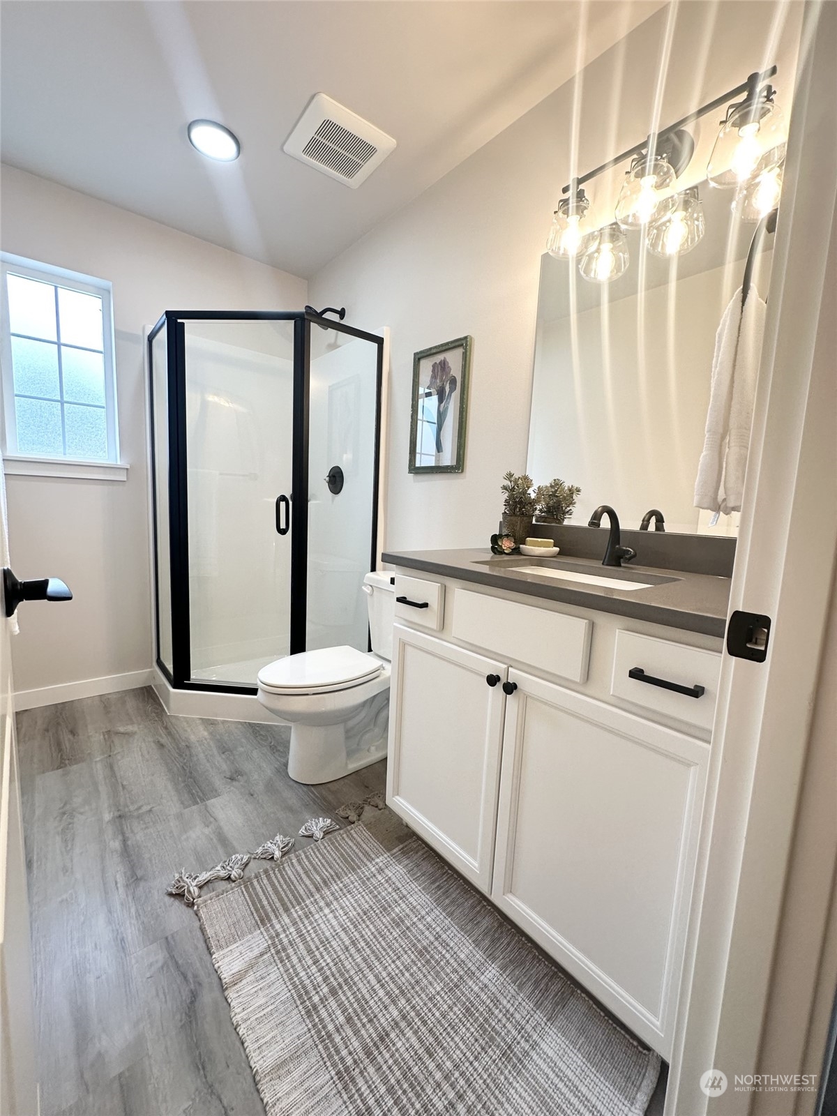 1733 Sunup Loop Bellingham, WA 98226 - Photo 13 of 16 a bathroom with a sink a toilet and a large mirror