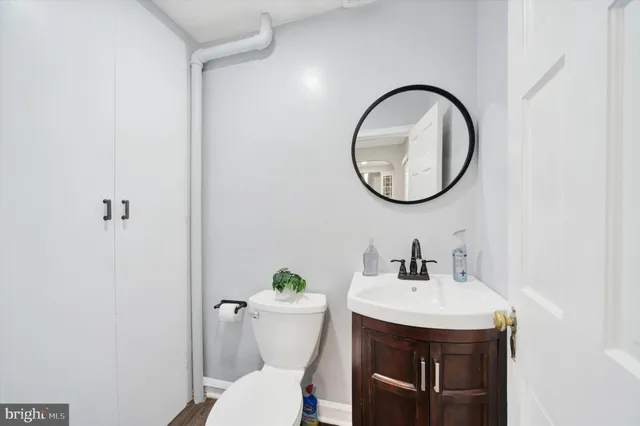 a bathroom with a toilet a sink and a mirror