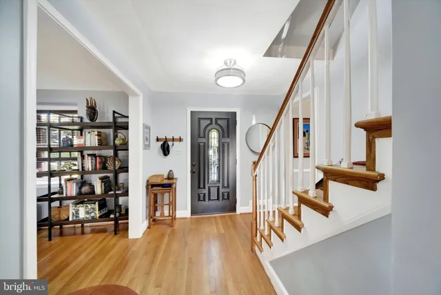 a view of entryway and hall with wooden floor