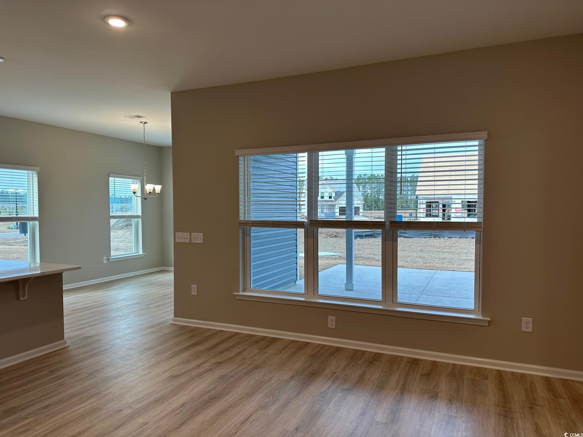 5223 Lucy Way Myrtle Beach, SC 29579 - Photo 7 of 27 Unfurnished room with a chandelier and hardwood /
